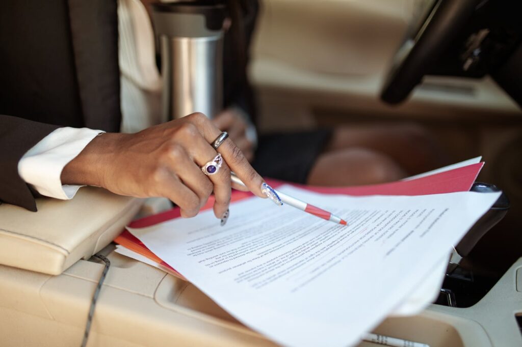 a woman in a car reading paperwork for shipping a car from Colorado to California