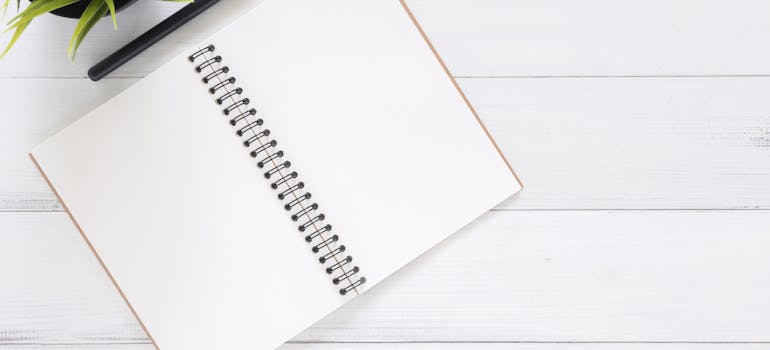 White blank notebook to plan relocating in a skyscraper in New York City