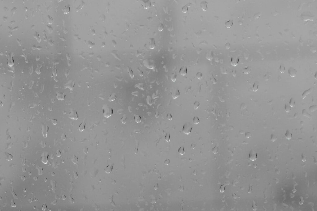window glass covered with rain drops