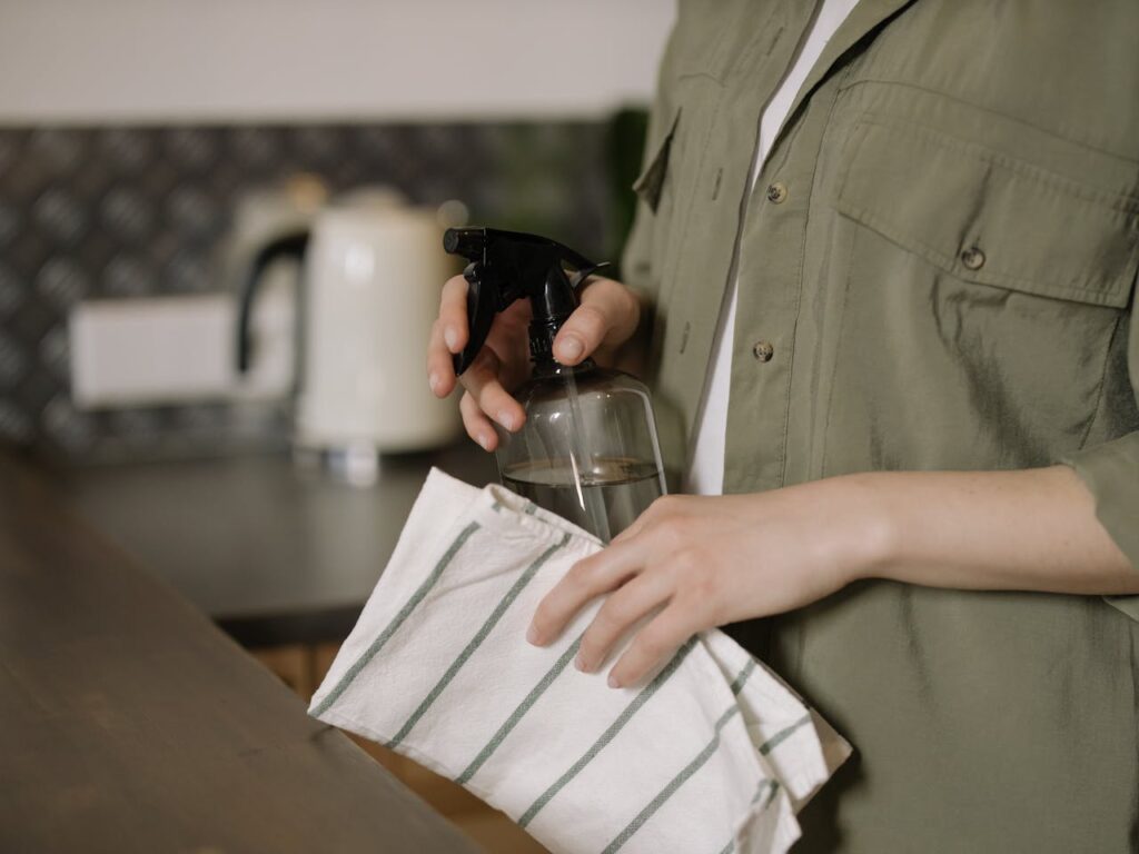 person holding cleaning products