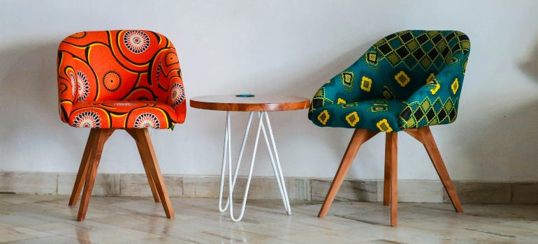 Two Assorted-color Padded Chairs Near Side Table