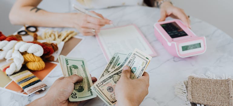two people calculating costs and counting money when moving to NYC