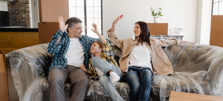 family sitting on a couch after moving