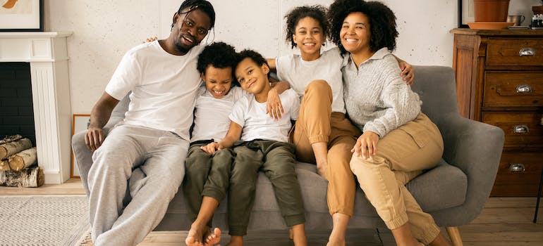 family of five sitting on a couch