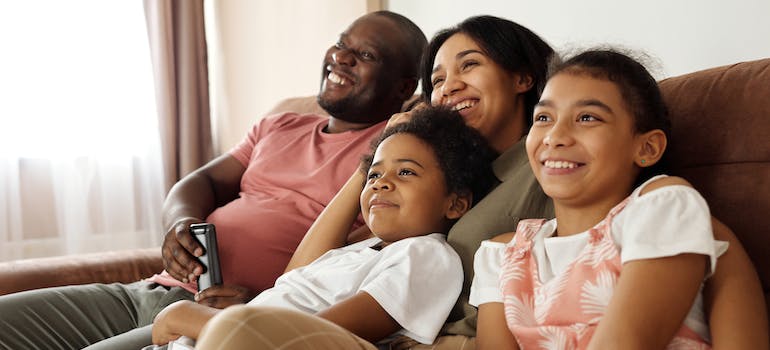 family smiling while sitting