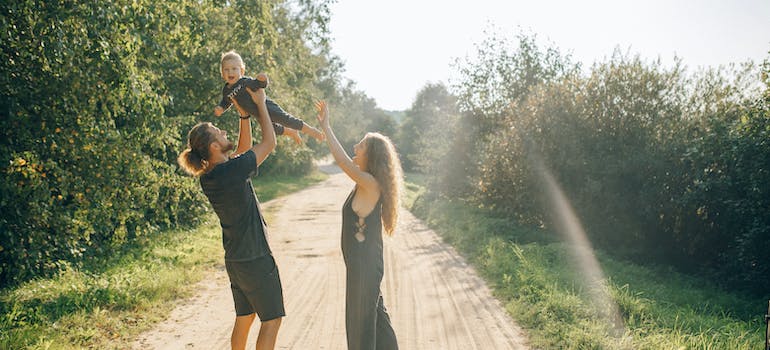a couple with a baby on a road