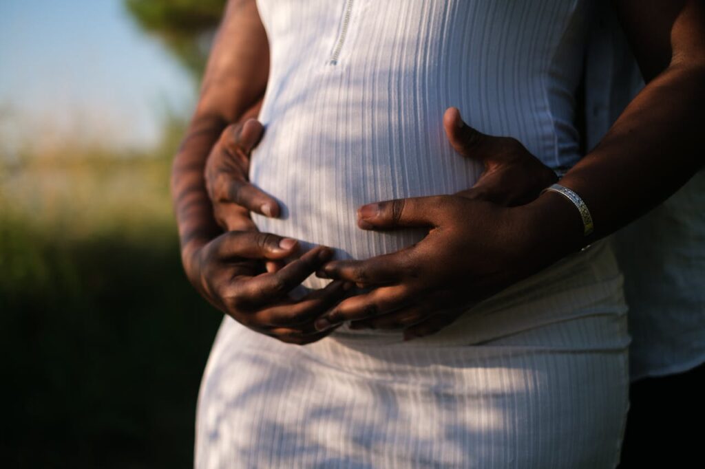 hands of a couple embracing the baby inside the belly