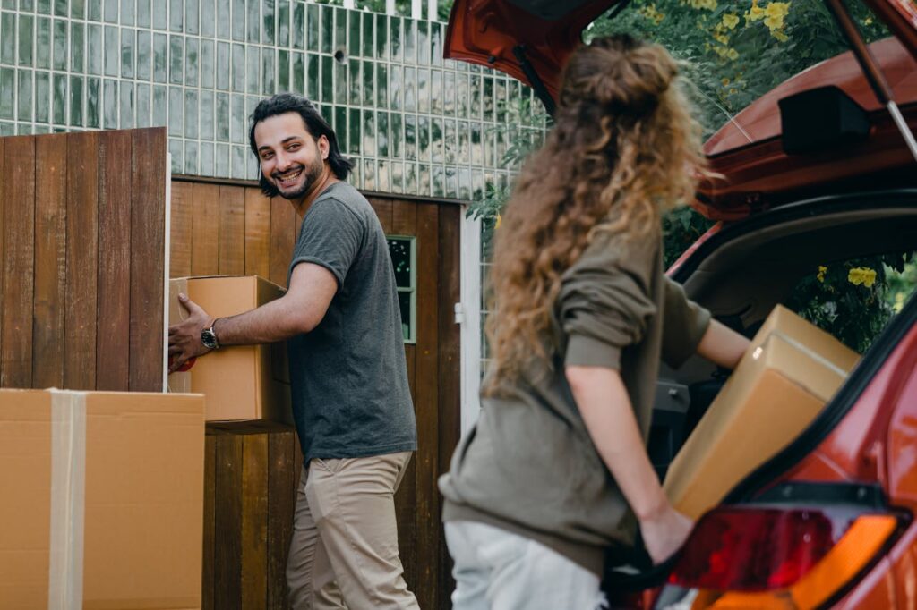 man and woman packing stuff into their car