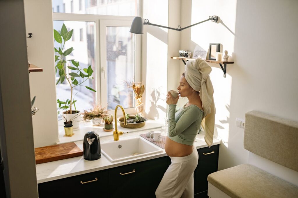 woman drinking coffee in her kitchen