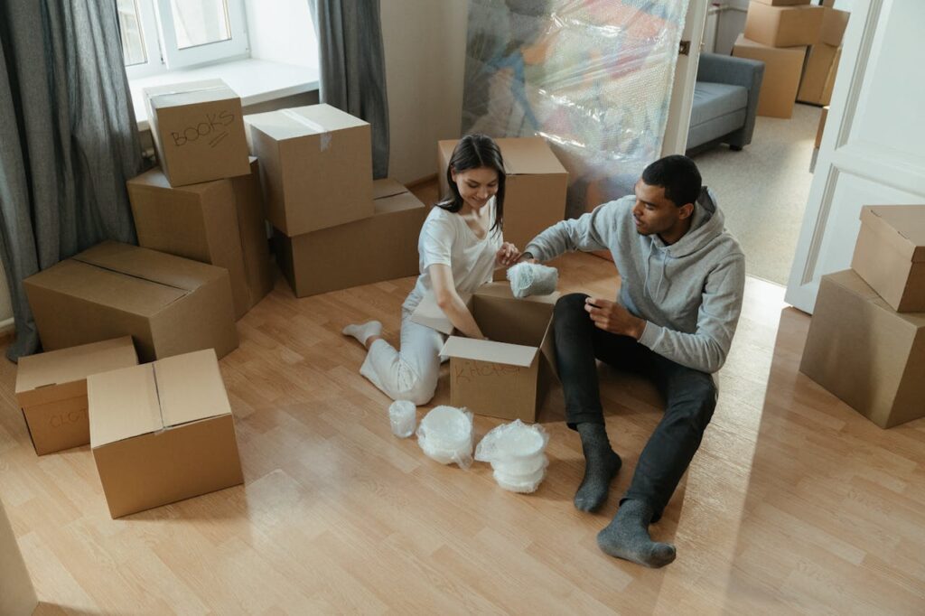 man and woman unpacking boxes