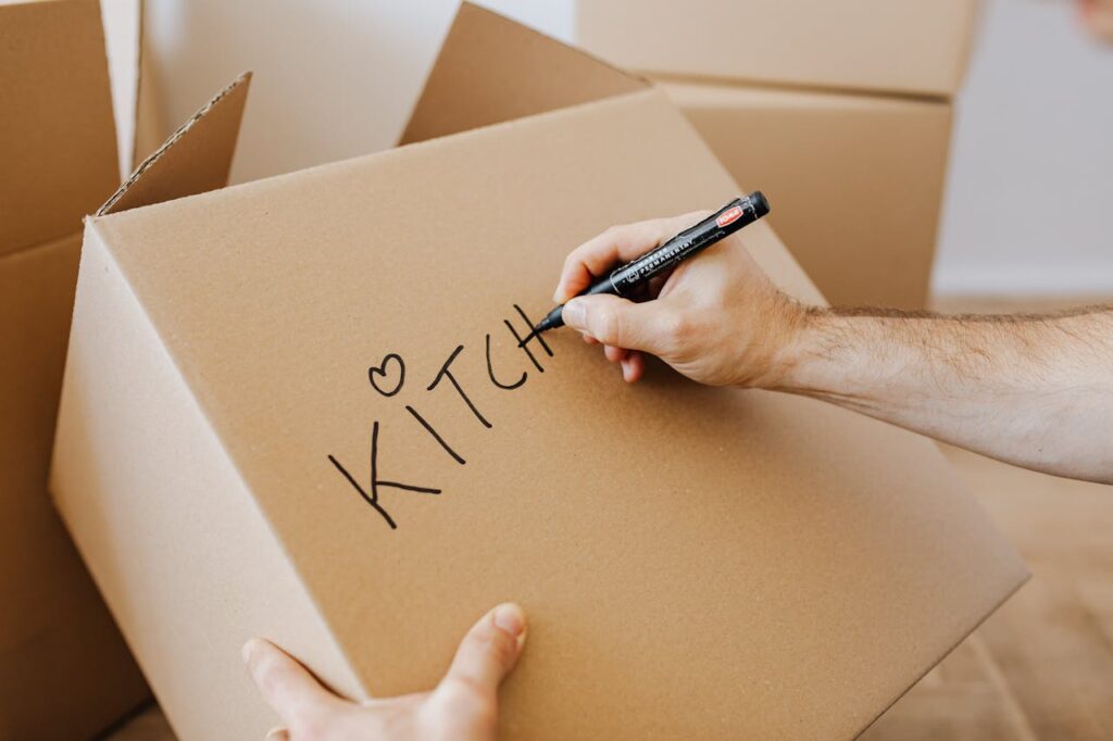 man writing on a box