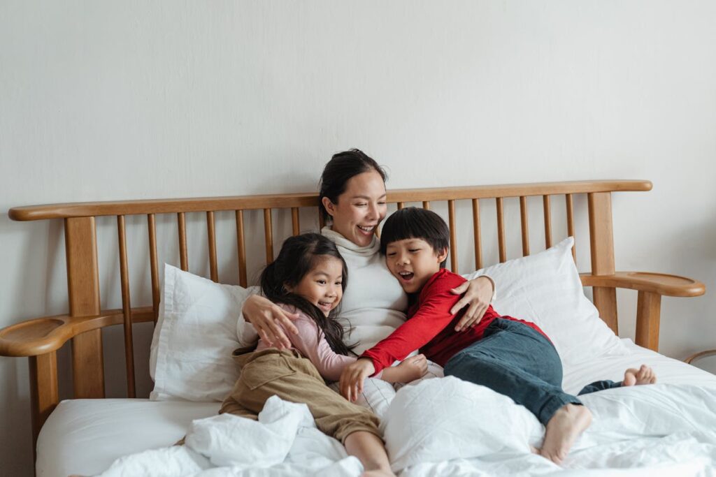 woman in bed with children