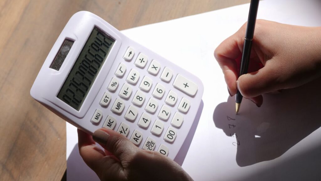 person using white calculator