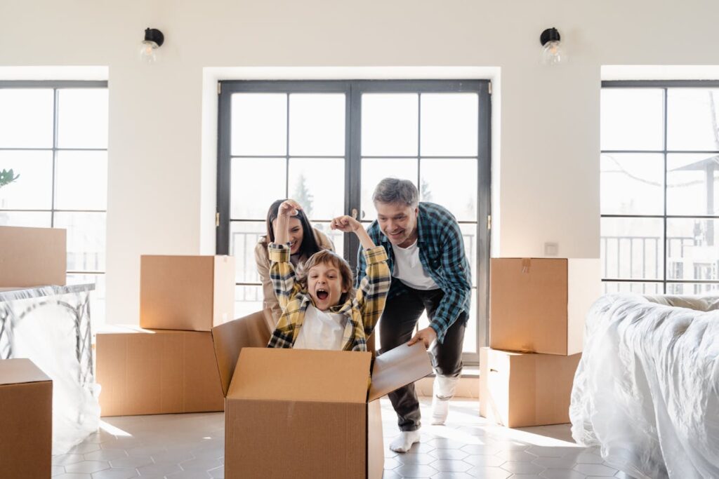 family of three having fun with boxes
