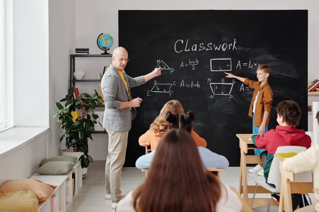 students and male teacher in a classroom