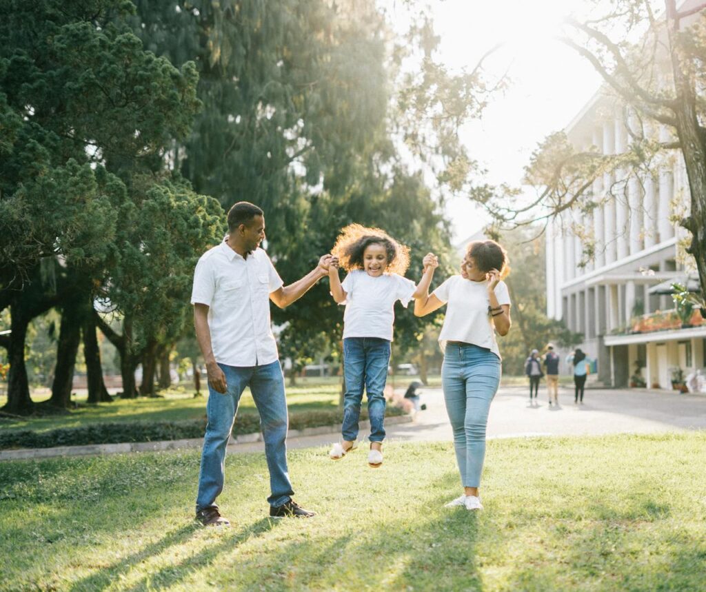 family of three having fun in a park