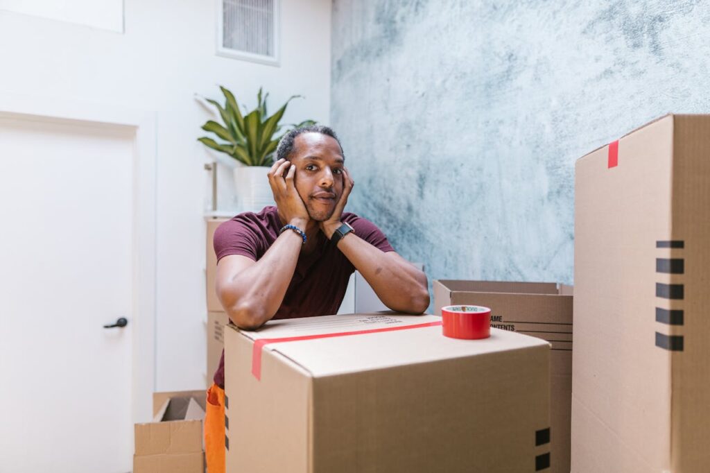man standing among boxes