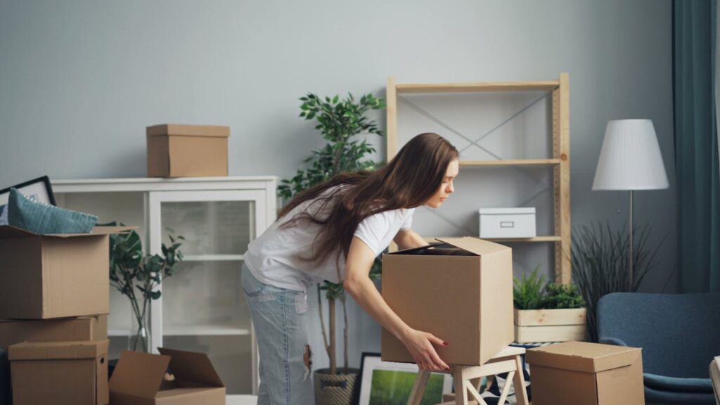 woman picking up the box