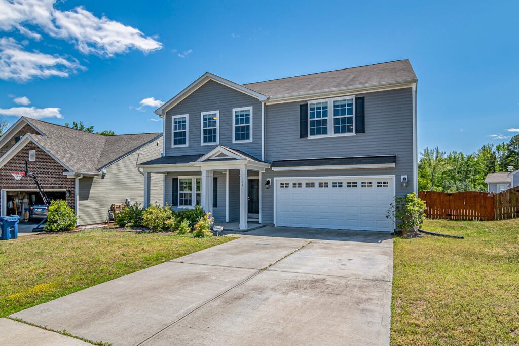 A Gray House with a Driveway
