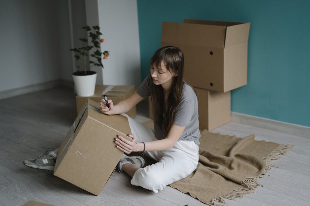 woman holding a box and a pen