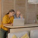 A Couple Looking at a Laptop and reading about the best places to retire in Maryland