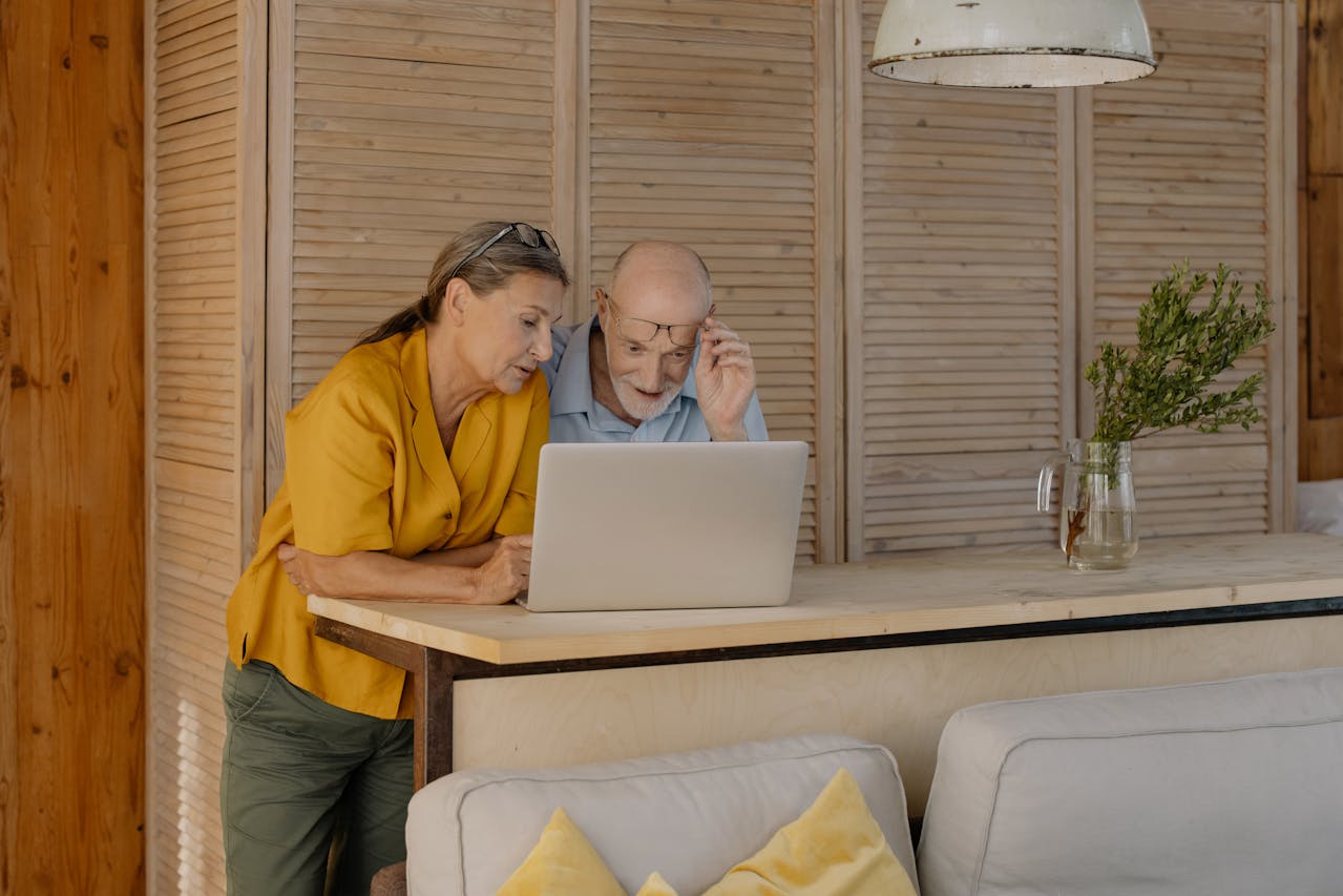 A Couple Looking at a Laptop and reading about the best places to retire in Maryland