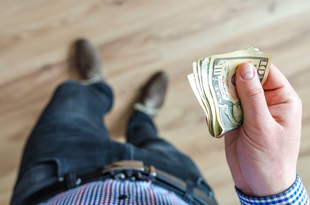Man Holds 10 U.s Dollar Banknote

