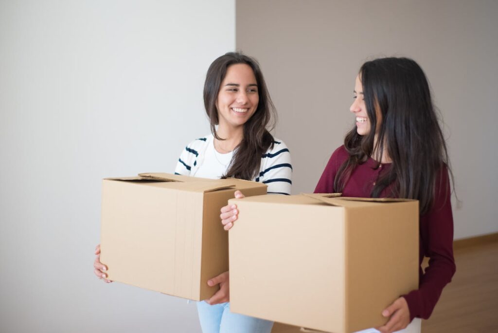 two young girls holding boxes