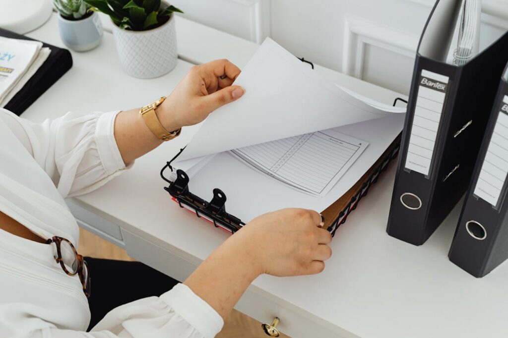 A Person Holding White Printer Paper
