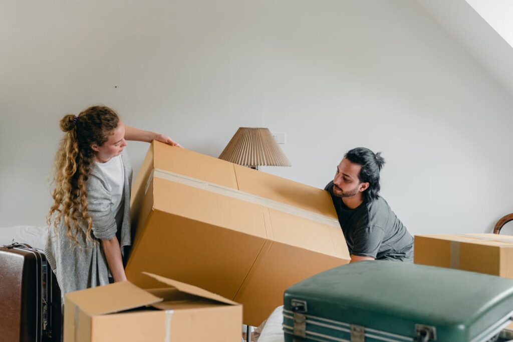 couple holding big box and preparing for moving from Massachusetts to Nebraska