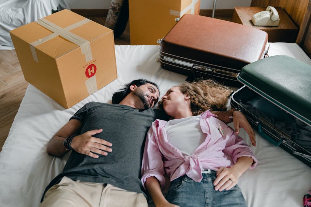 couple lying among boxes