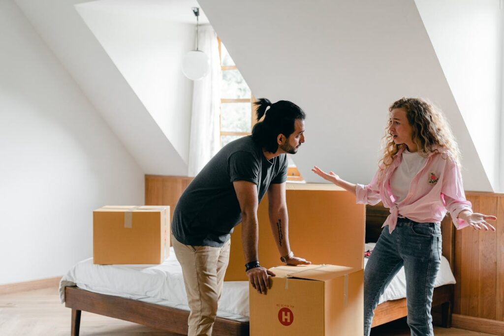 Multiracial couple communicating in new light bedroom
