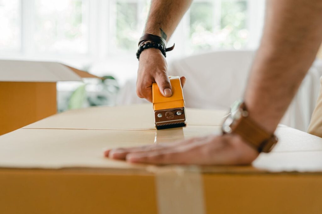 man closing a box