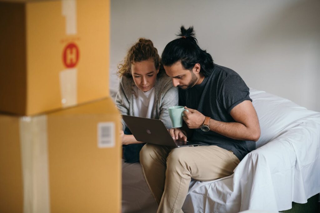 couple sitting and using laptop