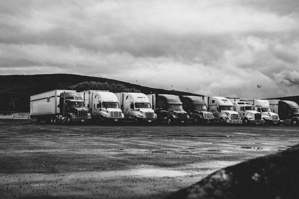 Parked Trucks Under Clouds
