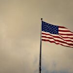 Photo of Cloudy Skies over American Flag