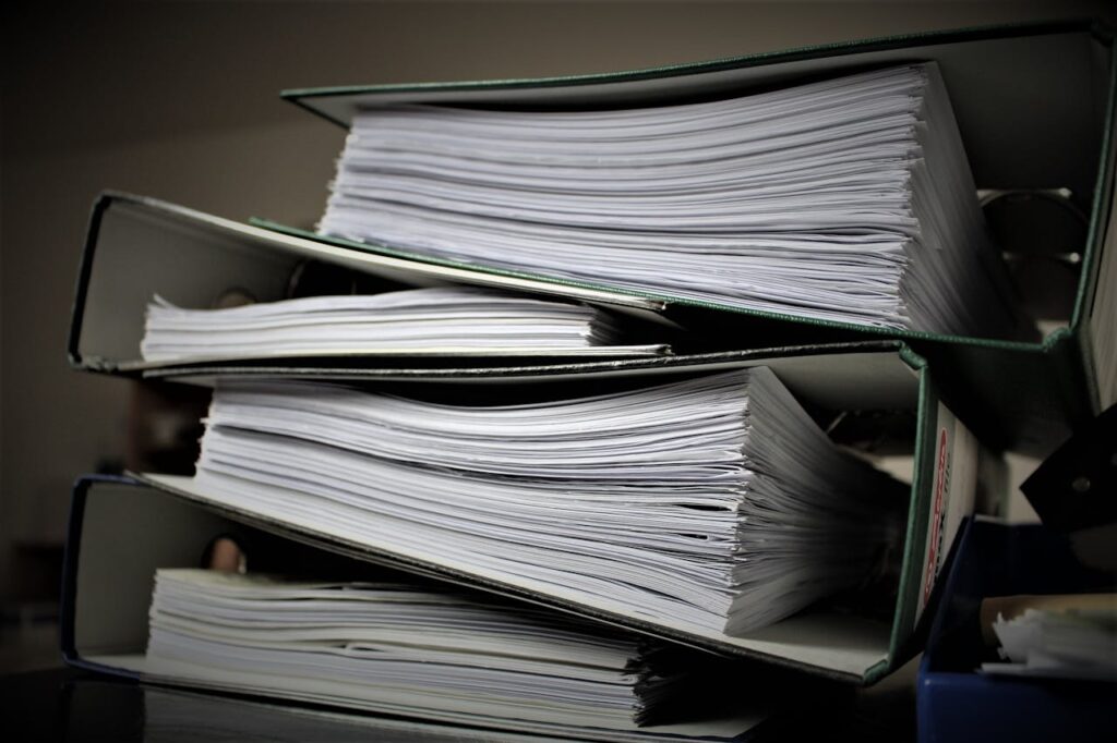 Pile of Folders with Documentation you will need for a cross-country move
