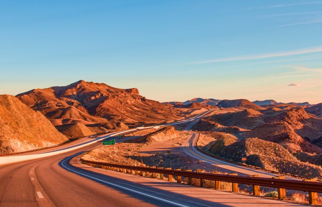 Landscape Photography of Rock Formation Near Highway
