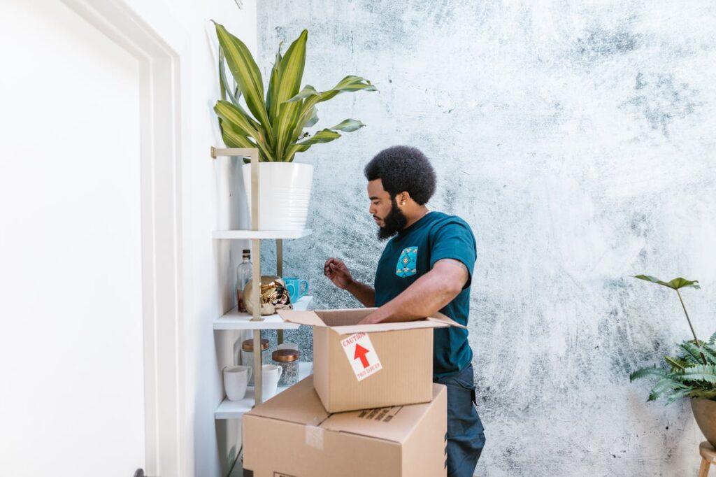 man standing near boxes