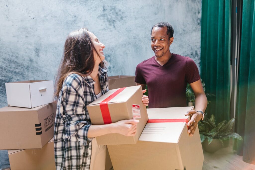 man and woman holding boxes