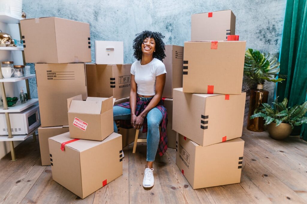 woman sitting among boxes