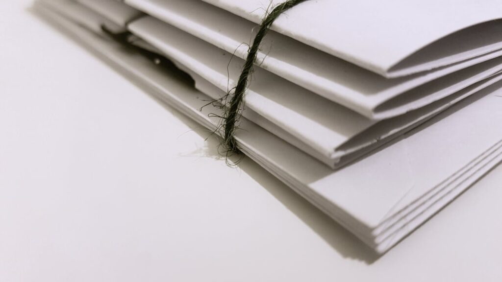 White Paper Folders With Black Tie
