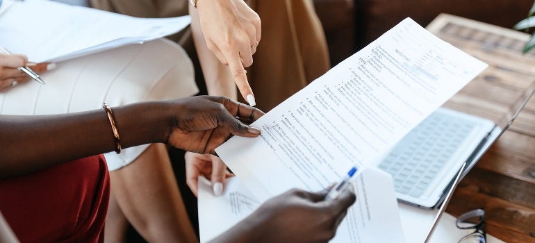 Two persons are checking the contract. 