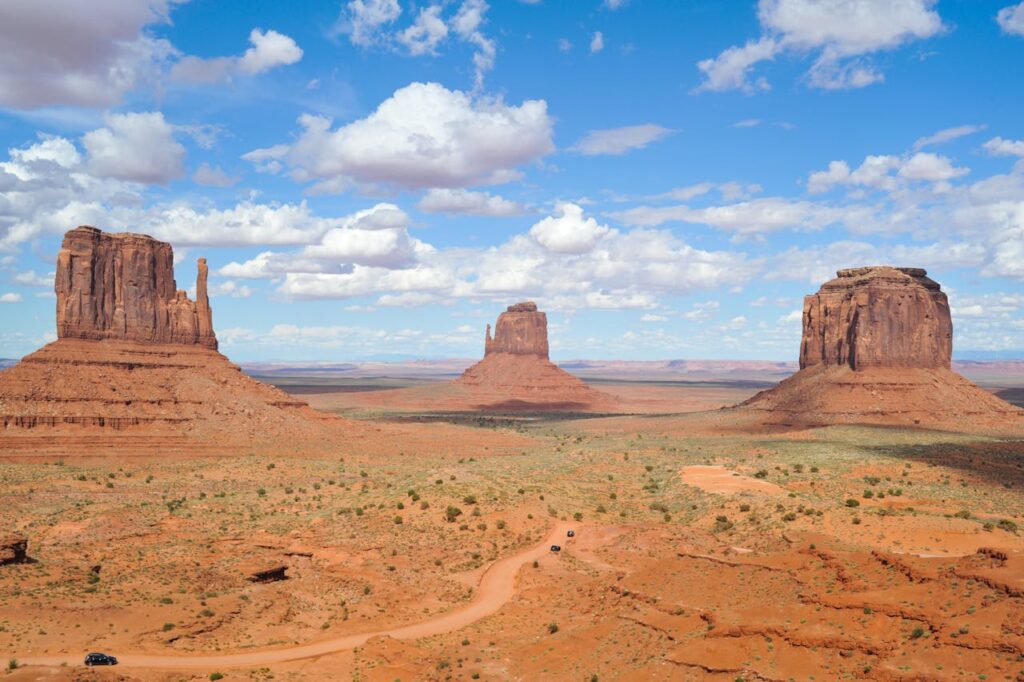 Brown Rock Formation Under White and Blue Cloudy Sky
