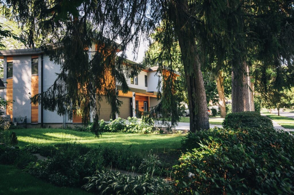 White Painted House Near Green Leafed Trees
