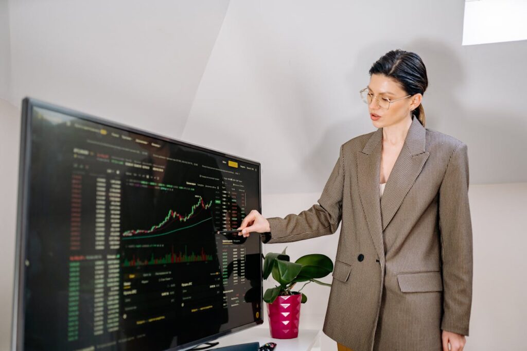 A Woman in Brown Blazer is Standing Beside the Computer Monitor