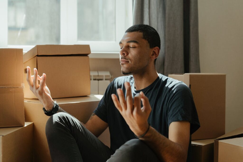 Man in Black Crew Neck T-shirt Sitting on Brown Sofa
