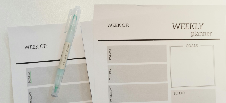 Weekly planner and a pen