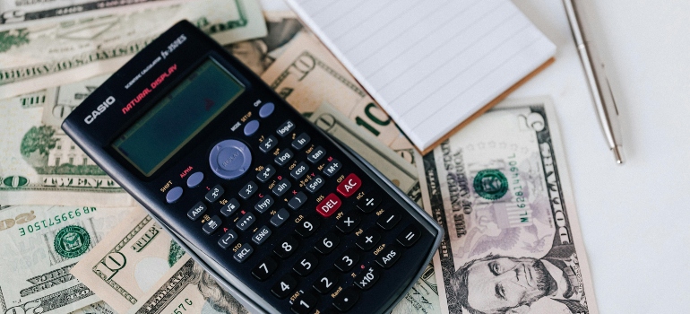 Money, calculator, paper and pencil 