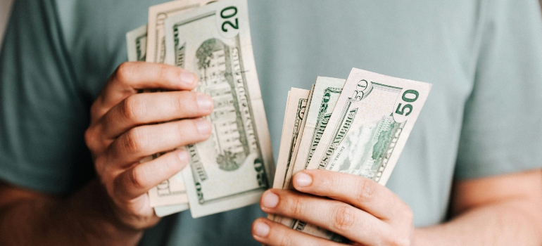 The man is counting money.